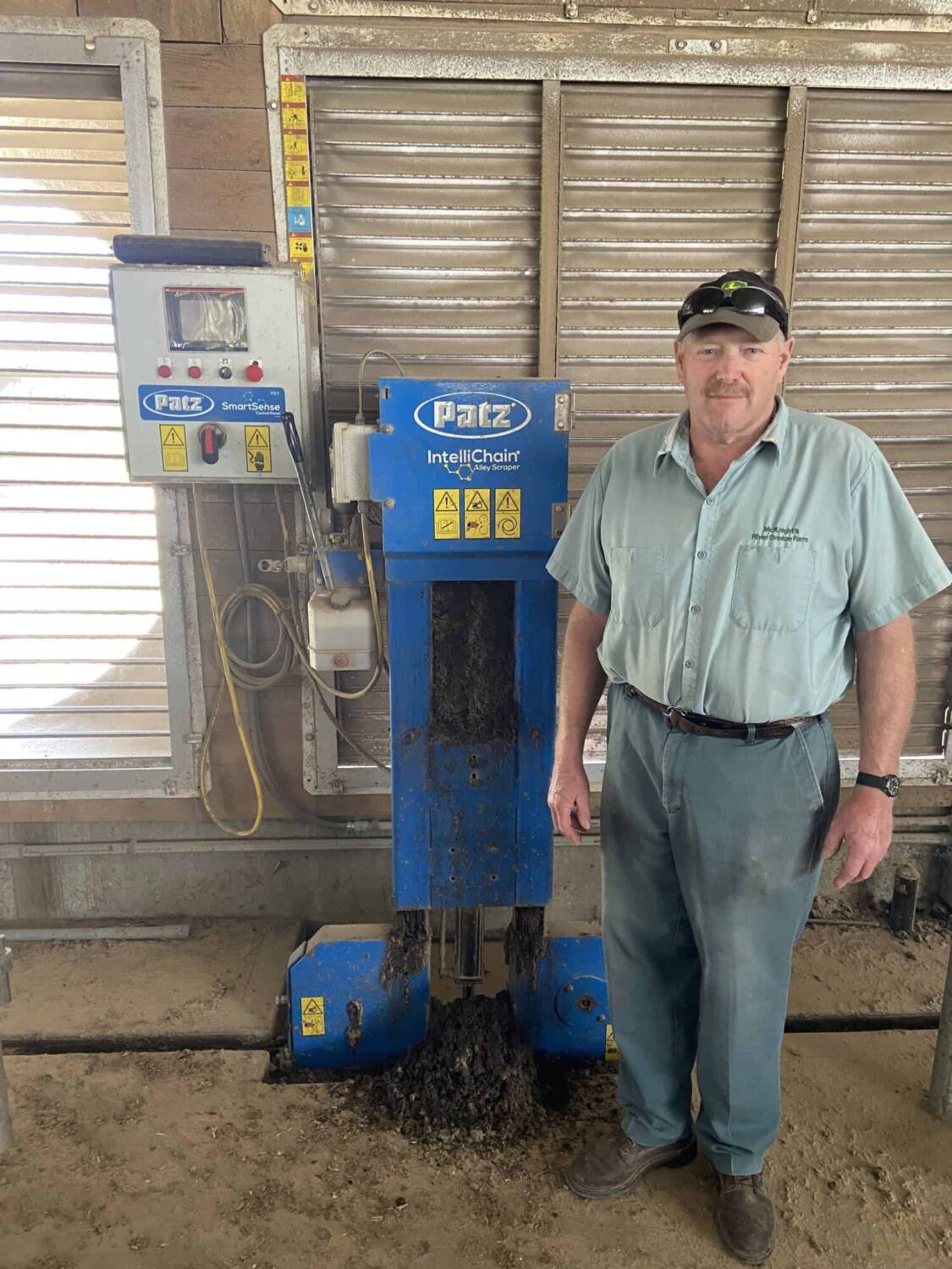 Patz customer - Stephen McKnight - standing by Patz IntelliChain in barn