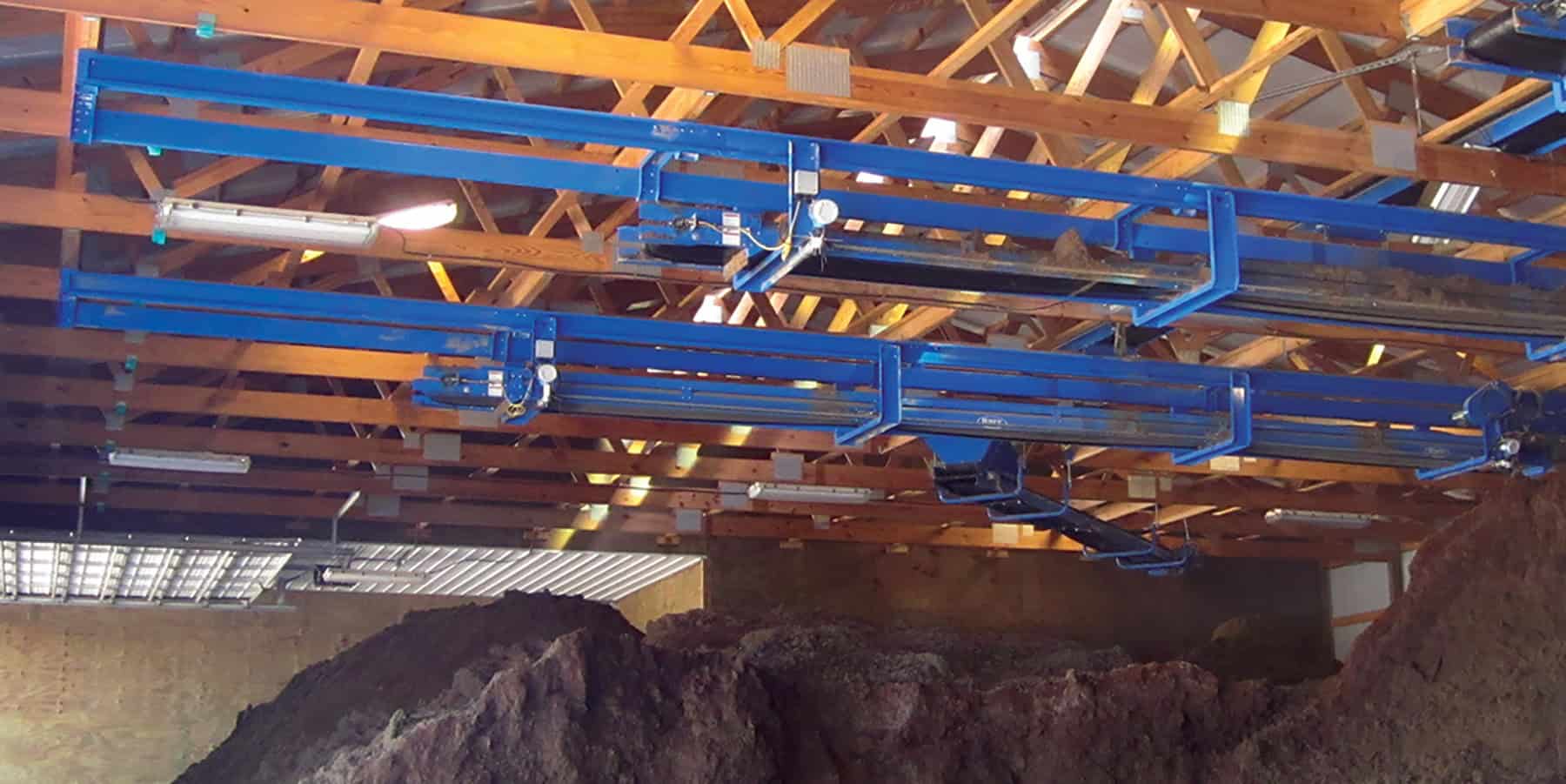 Patz conveyors mounted to the rafters of a storage room.