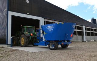 Patz 1200 Series II 420 Trailer Single Auger Vertical Mixer entering barn